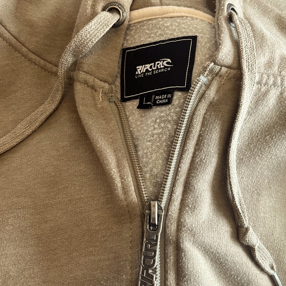 Mens Rip Curl light weight zip up hoodie. More on the tan/brown side.